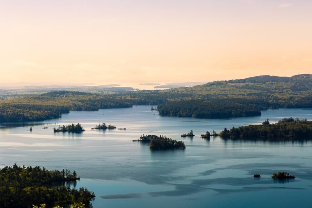 Aerial view of New Hampshire Lakes Region with mountains and crystal-clear water